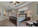 Spacious main bedroom with a ceiling fan and cozy sitting area at 4530 Roanoak Way, Palm Harbor, FL 34685
