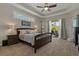 Bright main bedroom with a ceiling fan and a glimpse of the pool at 4530 Roanoak Way, Palm Harbor, FL 34685