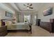 Bright main bedroom with a ceiling fan and a glimpse of the pool at 4530 Roanoak Way, Palm Harbor, FL 34685