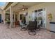 Covered brick patio has ample seating, a ceiling fan, and screened-in pool view at 4530 Roanoak Way, Palm Harbor, FL 34685