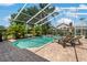 Sparkling screened pool with lush landscaping and brick paved deck, perfect for relaxation and entertainment at 4530 Roanoak Way, Palm Harbor, FL 34685