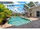 Relaxing screened pool area with brick pavers, lounge chairs, and lush landscaping at 4530 Roanoak Way, Palm Harbor, FL 34685