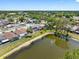Aerial view of neighborhood homes bordering a lush pond at 4813 Glenaire Ct, Tampa, FL 33624