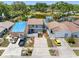 Aerial view of houses with well-manicured lawns, driveways, and colorful cars at 4813 Glenaire Ct, Tampa, FL 33624