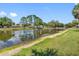 Aerial view of a scenic lake surrounded by lush trees and houses at 4813 Glenaire Ct, Tampa, FL 33624
