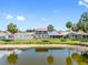 Aerial view of the backyard with white fence, overlooking a tranquil pond at 4813 Glenaire Ct, Tampa, FL 33624