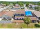 Aerial view of fenced backyard with mature landscaping and a charming patio at 4813 Glenaire Ct, Tampa, FL 33624