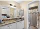 Bathroom featuring a large mirror, granite countertop, and a separate shower room at 4813 Glenaire Ct, Tampa, FL 33624