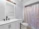 Clean bathroom features a white vanity, modern black faucet, and a shower with decorative curtain at 4813 Glenaire Ct, Tampa, FL 33624