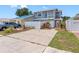 Charming two-story home with a well-kept lawn, driveway, and colorful garden at 4813 Glenaire Ct, Tampa, FL 33624