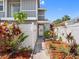 Charming home entrance with colorful landscaping and a white fence offering curb appeal and privacy at 4813 Glenaire Ct, Tampa, FL 33624