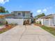 Well-maintained two-story home featuring a fenced yard, colorful landscaping, and a spacious driveway at 4813 Glenaire Ct, Tampa, FL 33624