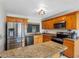 Functional kitchen with granite counters, wood cabinets, and stainless steel appliances, perfect for cooking at 4813 Glenaire Ct, Tampa, FL 33624