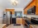 Well-lit kitchen featuring granite countertops, wood cabinets, and stainless steel appliances at 4813 Glenaire Ct, Tampa, FL 33624