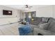 Inviting living room with tile floors, a cozy sectional sofa, and sliding doors for natural light at 4813 Glenaire Ct, Tampa, FL 33624