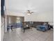 Spacious living room featuring tile floors, comfortable sectional seating, and a sliding glass door at 4813 Glenaire Ct, Tampa, FL 33624