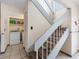 Staircase next to a laundry area with white washer and dryer, and tiled floor at 4813 Glenaire Ct, Tampa, FL 33624