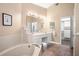 Bathroom featuring a soaking tub, dual vanities, and a separate water closet at 5205 Fairway One Dr, Valrico, FL 33596