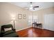 Bedroom with hardwood floors, a ceiling fan, and a comfortable reading nook at 5205 Fairway One Dr, Valrico, FL 33596
