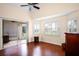 Bedroom with hardwood floors and an outdoor patio view through the glass doors at 5205 Fairway One Dr, Valrico, FL 33596