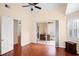 Bedroom with hardwood floors, and a sliding glass door to an outdoor patio at 5205 Fairway One Dr, Valrico, FL 33596