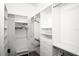 Walk-in closet features built-in shelves, drawers, and hanging rods at 5205 Fairway One Dr, Valrico, FL 33596
