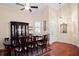 Elegant dining room features a wood table, cabinet, and decorative chandelier at 5205 Fairway One Dr, Valrico, FL 33596
