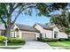 Well maintained house featuring an attached garage and a driveway with manicured landscaping at 5205 Fairway One Dr, Valrico, FL 33596