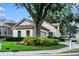 Charming home with a well-manicured lawn, a mature tree, and tasteful landscaping at 5205 Fairway One Dr, Valrico, FL 33596