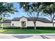 Lovely property boasting a manicured lawn, mature trees, and an attached garage at 5205 Fairway One Dr, Valrico, FL 33596