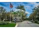 Exterior shot of community entrance and guard house with mature landscaping at 5205 Fairway One Dr, Valrico, FL 33596