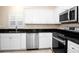 Modern kitchen featuring stainless steel appliances and dark countertops at 5205 Fairway One Dr, Valrico, FL 33596