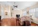 Spacious living room featuring hardwood floors, a ceiling fan, and shuttered windows at 5205 Fairway One Dr, Valrico, FL 33596