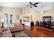 Open concept living room with hardwood floors, wet bar, and adjacent dining area at 5205 Fairway One Dr, Valrico, FL 33596