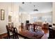 Bright living room features a dining table, elegant lighting, and comfortable seating area at 5205 Fairway One Dr, Valrico, FL 33596