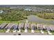 An aerial view of a neighborhood with a community pond and lush greenery at 5411 Thistle Field Ct, Wesley Chapel, FL 33545