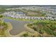 Beautiful aerial view of a lakeside community with well-maintained homes and lush landscaping at 5411 Thistle Field Ct, Wesley Chapel, FL 33545