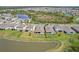 Aerial view of a home with a fenced backyard in a community near a peaceful lake setting at 5411 Thistle Field Ct, Wesley Chapel, FL 33545