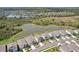 An aerial view showcasing homes in a community near a picturesque lake at 5411 Thistle Field Ct, Wesley Chapel, FL 33545