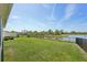 A beautiful backyard with a serene lake view and fenced yard at 5411 Thistle Field Ct, Wesley Chapel, FL 33545