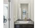 Half bathroom with granite vanity and a framed mirror at 5411 Thistle Field Ct, Wesley Chapel, FL 33545