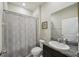 Bathroom with a shower curtain, granite vanity and mirror at 5411 Thistle Field Ct, Wesley Chapel, FL 33545