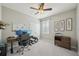 Bedroom with a ceiling fan, shuttered window, and desk setup at 5411 Thistle Field Ct, Wesley Chapel, FL 33545