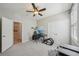 Bedroom featuring a ceiling fan and double closets, adjacent to a bathroom at 5411 Thistle Field Ct, Wesley Chapel, FL 33545