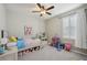 bedroom featuring a ceiling fan and shuttered window at 5411 Thistle Field Ct, Wesley Chapel, FL 33545