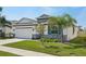 Lovely single-story home with stone accents, lush landscaping, and an inviting two-car garage at 5411 Thistle Field Ct, Wesley Chapel, FL 33545
