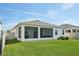 A home exterior shows the well-maintained yard with a fenced backyard and patio at 5411 Thistle Field Ct, Wesley Chapel, FL 33545
