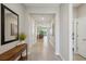 Bright hallway with tile floors, neutral paint, and an open view into the living room at 5411 Thistle Field Ct, Wesley Chapel, FL 33545