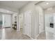 Inviting home entryway with tiled flooring, neutral walls, and multiple doorways at 5411 Thistle Field Ct, Wesley Chapel, FL 33545