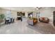 Open concept living area with dark cabinets, connecting the kitchen, living, and dining spaces at 5411 Thistle Field Ct, Wesley Chapel, FL 33545